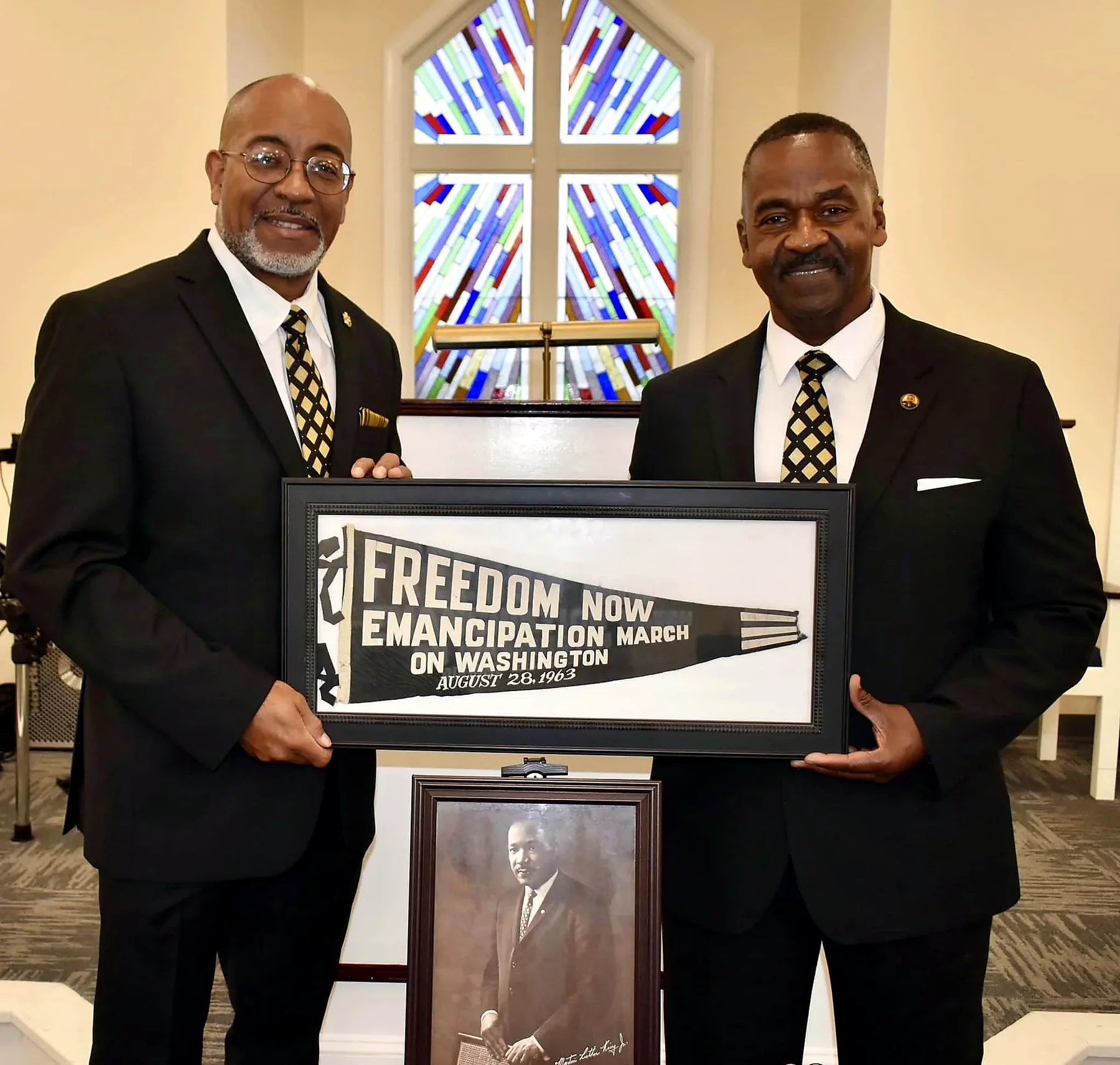 Rev. Moore holding a March on Washington commemorative banner